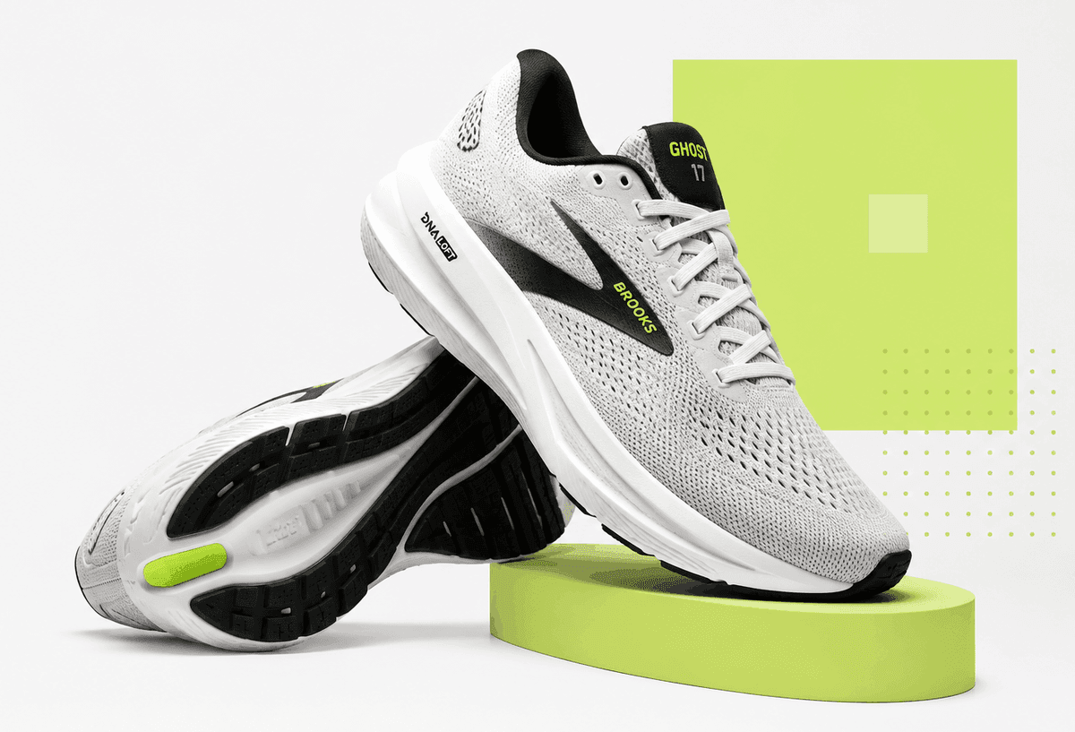 A pair of cushioned road running shoes, one upright and one tipped onto its side to show the outsole.